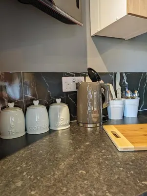 a kitchen counter with three coffee pots on it at Lake View lodges The Lavenham in Long Melford
