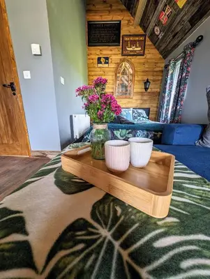 a table with two white bowls and flowers on it at Lake View lodges The Lavenham in Long Melford