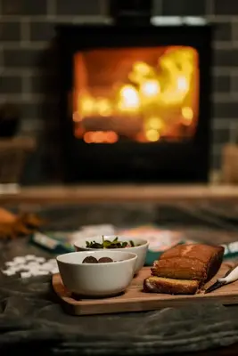 two bowls of food on a cutting board with bread at Honeywood Farm Cabins in Woodham Ferrers