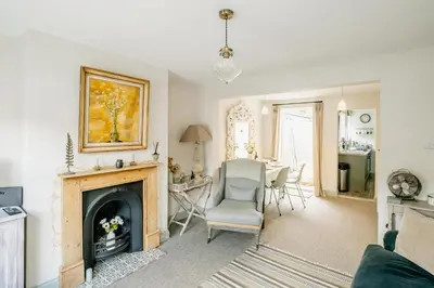 a living room with a fireplace and a table and chairs at Wigeon Cottage, Aldeburgh - Sleeps 4 - Adults only house in Aldeburgh