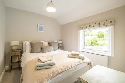 a bedroom with a bed with two towels on it at Wigeon Cottage, Aldeburgh - Sleeps 4 - Adults only house in Aldeburgh