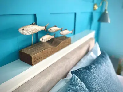 a shelf with fish figurines on top of a bed at 2 Bedroom Apartment with Garden, Close to Beach in Southend-on-Sea