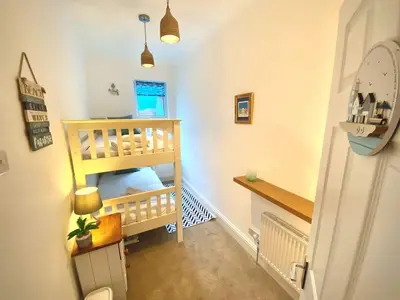 a room with a staircase with a bunk bed at 2 Bedroom Apartment with Garden, Close to Beach in Southend-on-Sea