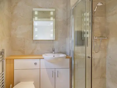 a bathroom with a sink and a shower at Barrow Barn in Wicken