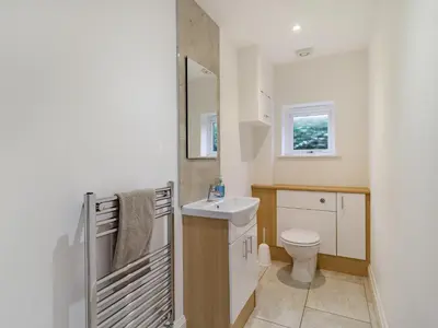 a bathroom with a toilet and a sink at Barrow Barn in Wicken