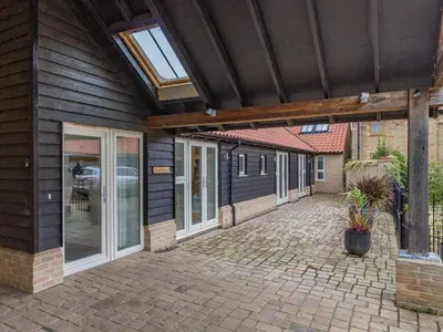 a patio of a house with a wooden roof at Barrow Barn in Wicken