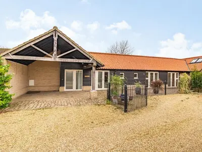 a house with an orange roof and a driveway at Barrow Barn in Wicken