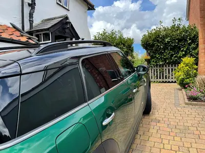 a green car parked in front of a house at Walnut Cottage in Sproughton