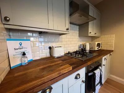 a kitchen with white cabinets and a counter top at Luxury 1 Bedroom Apartment in Southend w Parking in Southend-on-Sea