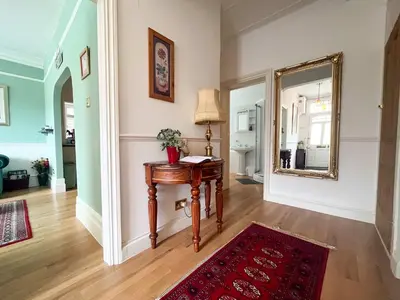a living room with a table and a mirror at Luxury 1 Bedroom Apartment in Southend w Parking in Southend-on-Sea