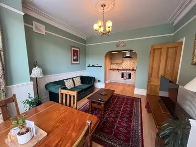 a living room with a couch and a table at Luxury 1 Bedroom Apartment in Southend w Parking in Southend-on-Sea