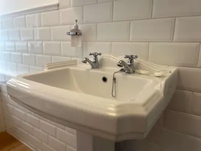 a white sink with two faucets in a bathroom at Luxury 1 Bedroom Apartment in Southend w Parking in Southend-on-Sea