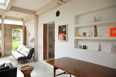 a living room with a table and a chair at The Skyroom in Rendham