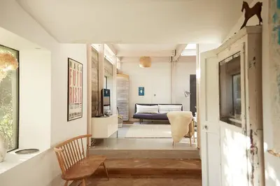 a living room with a couch and a chair at The Skyroom in Rendham