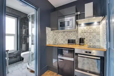 a kitchen with a sink and a microwave at Studio Apartments in Southend in Southend-on-Sea