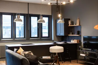 a living room with a couch and a counter with windows at St Johns Apartments & Studios Southend in Southend-on-Sea