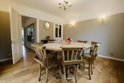 a dining room with a wooden table and chairs at Exquisite location close to the sea! in Frinton-on-Sea