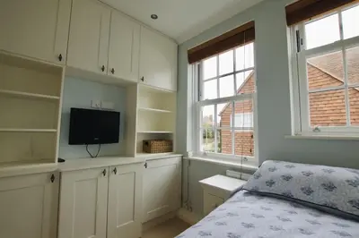 a bedroom with a bed and a flat screen tv at Exquisite location close to the sea! in Frinton-on-Sea