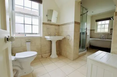 a bathroom with a toilet and a sink and a shower at Exquisite location close to the sea! in Frinton-on-Sea