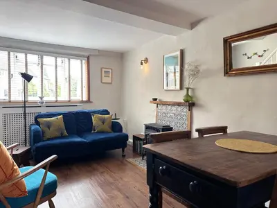 a living room with a blue couch and a table at Lavender Cottage, Clare in Clare