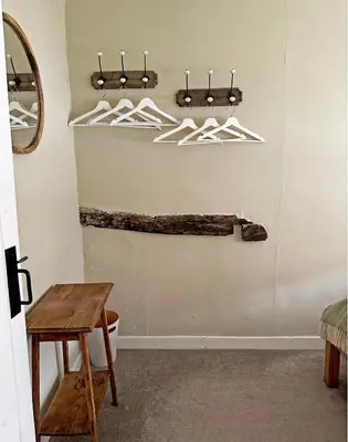 a bathroom with a toilet and hangers on the wall at Lavender Cottage, Clare in Clare