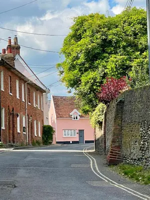 a street in a town with houses and a wall at Lavender Cottage, Clare in Clare