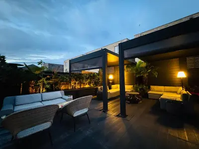 a living room with a couch and chairs on a patio at Stunning designer House in excellent city location in Cambridge