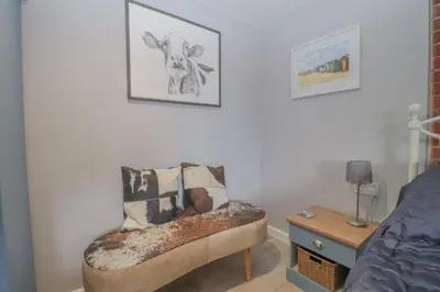a living room with a chair and a table at Charming dog friendly cottage in rural Suffolk in Eye