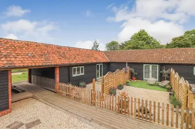 an image of a house with a wooden deck at Charming dog friendly cottage in rural Suffolk in Eye