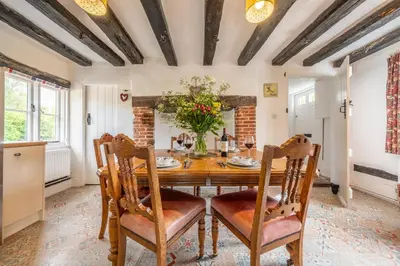 a dining room with a wooden table and chairs at Rural perfection in Constable Country - Beachams Cottage in Colchester