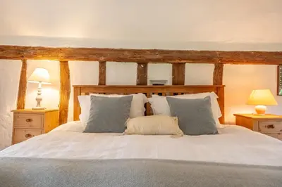 a bedroom with a large white bed with pillows at Rural perfection in Constable Country - Beachams Cottage in Colchester