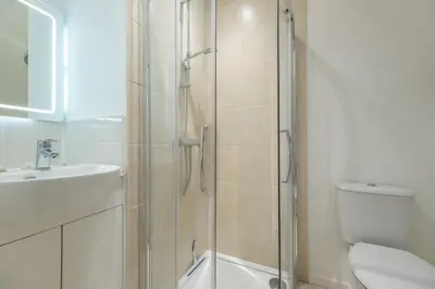 a bathroom with a shower and a toilet and a sink at Rural perfection in Constable Country - Beachams Cottage in Colchester