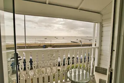 a balcony with a view of the beach at Beaches Guest House in Southend-on-Sea