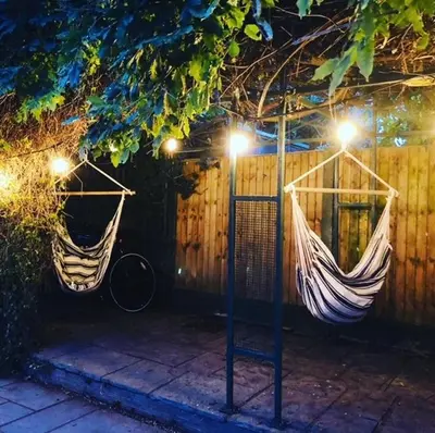 two hammocks hanging from a fence at night at Beaches Guest House in Southend-on-Sea
