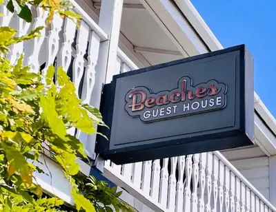 a sign for a guest house on the side of a building at Beaches Guest House in Southend-on-Sea