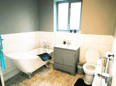 a bathroom with a tub and a sink and a toilet at Spacious 4-Bedroom Home, Sleeps 7, Family & Professional Friendly, Clark Property Estates in Southend-on-Sea