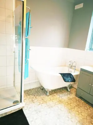 a bathroom with a tub and a shower and a sink at Spacious 4-Bedroom Home, Sleeps 7, Family & Professional Friendly, Clark Property Estates in Southend-on-Sea