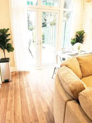 a living room with a couch and a table at Spacious 4-Bedroom Home, Sleeps 7, Family & Professional Friendly, Clark Property Estates in Southend-on-Sea