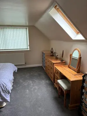 a bedroom with a bed and a desk and a mirror at A great country escape in Hockwold cum Wilton