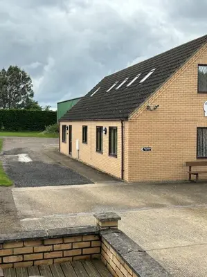 a brick building with a bench in front of it at A great country escape in Hockwold cum Wilton