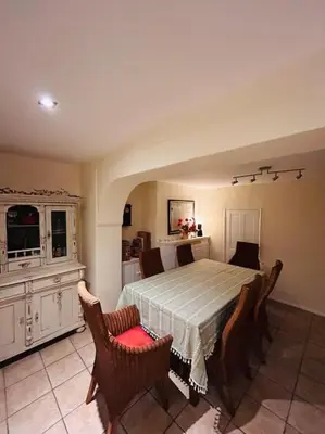 a bedroom with a bed with chairs and a table at Cottage K in Hinxton