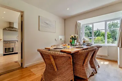 a dining room with a table with wicker chairs at 3 Bed in Snape oc-g29478 in Snape