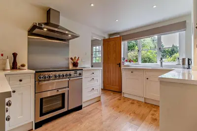 a kitchen with white cabinets and a stove top oven at 3 Bed in Snape oc-g29478 in Snape