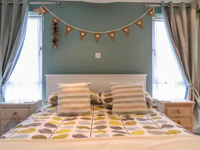 a bedroom with a bed with two pillows at Owls Retreat, Lodge 11 in Aldeburgh