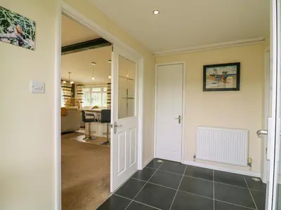 a hallway with a door leading into a room at Owls Retreat, Lodge 11 in Aldeburgh