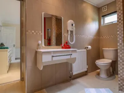 a bathroom with a sink and a toilet at Owls Retreat, Lodge 11 in Aldeburgh