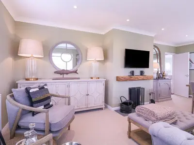 a living room with a couch and a tv at The Farmhouse in Clacton-on-Sea