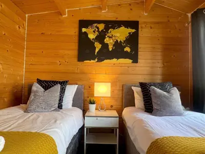 two beds in a room with a map on the wall at Duchess Lodge In Colchester 1BR,Couples, Contractors,Business Travellers, Free WIFI, Secure Parking in Colchester