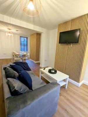 a living room with a couch and a table at 3-Bed, Sleeps 6, 1 Bath, Parking, WiFi in Halstead