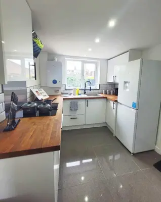 a kitchen with white appliances and a wooden counter top at 3-Bed, Sleeps 6, 1 Bath, Parking, WiFi in Halstead